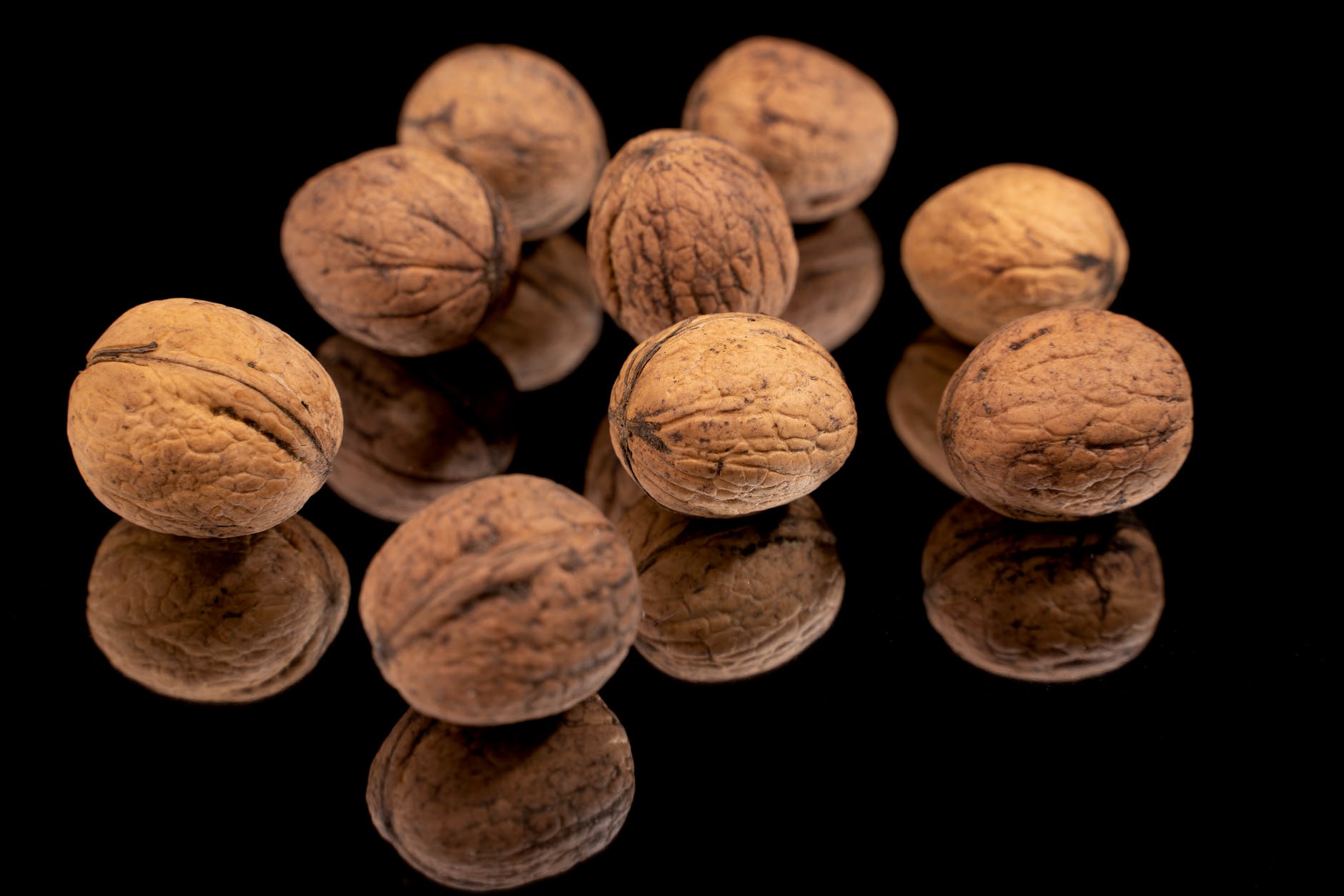 close up shot of walnuts on a black surface